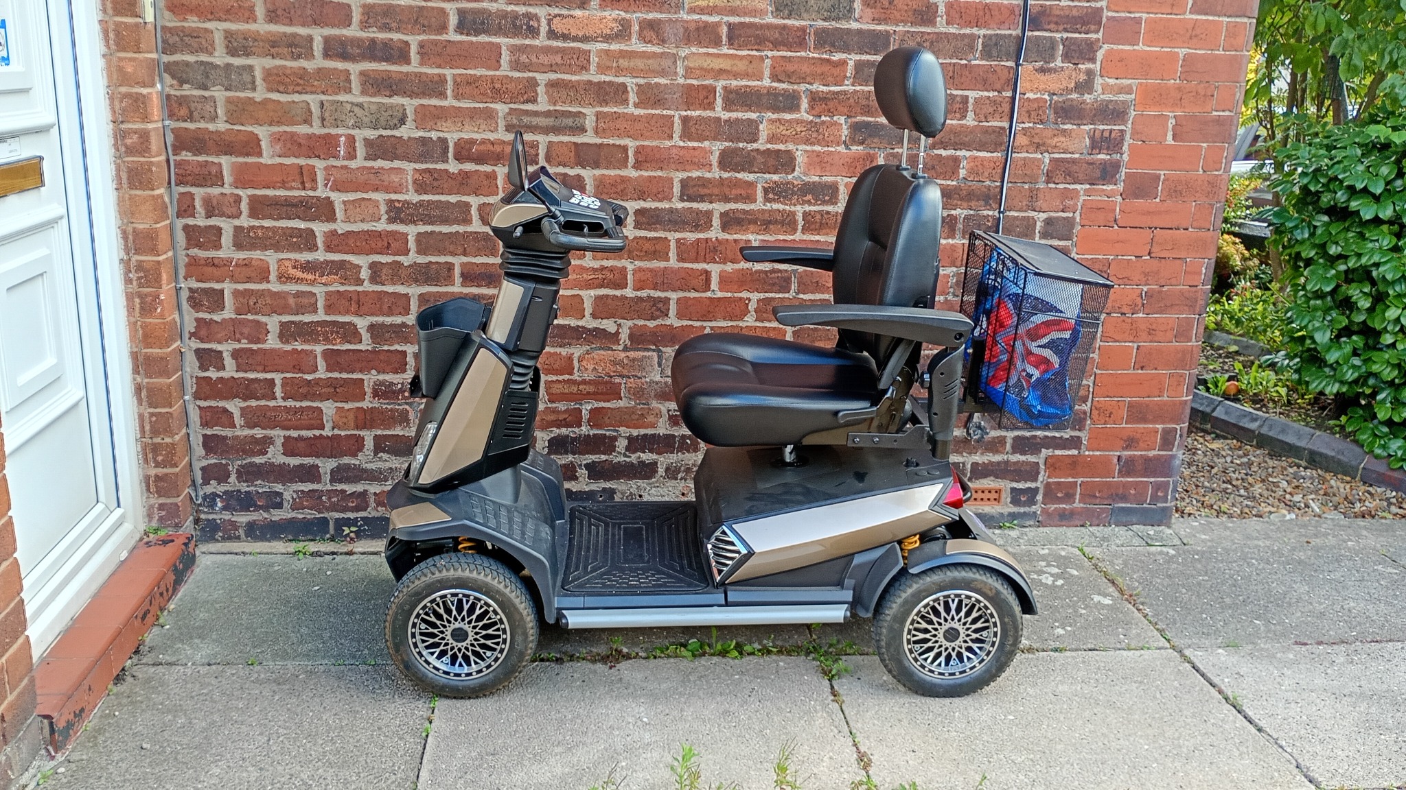 Dave and Norma's large mobility scooter parked outside their home