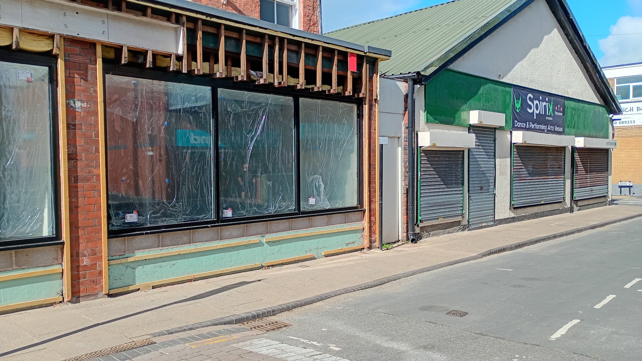 Shuttered and boarded former family businesses on a local street