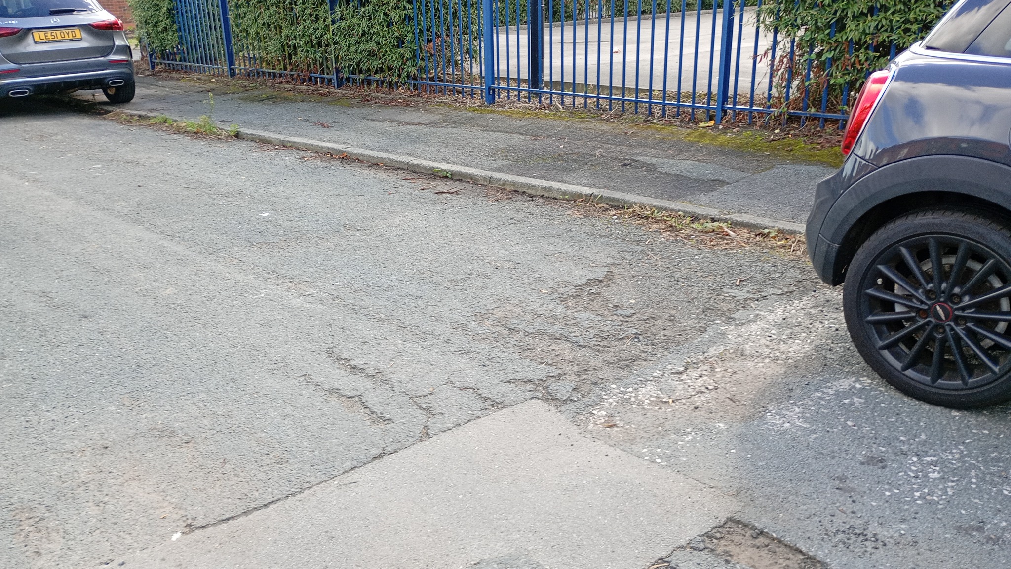 A pothole and damaged road surface on Dave's street