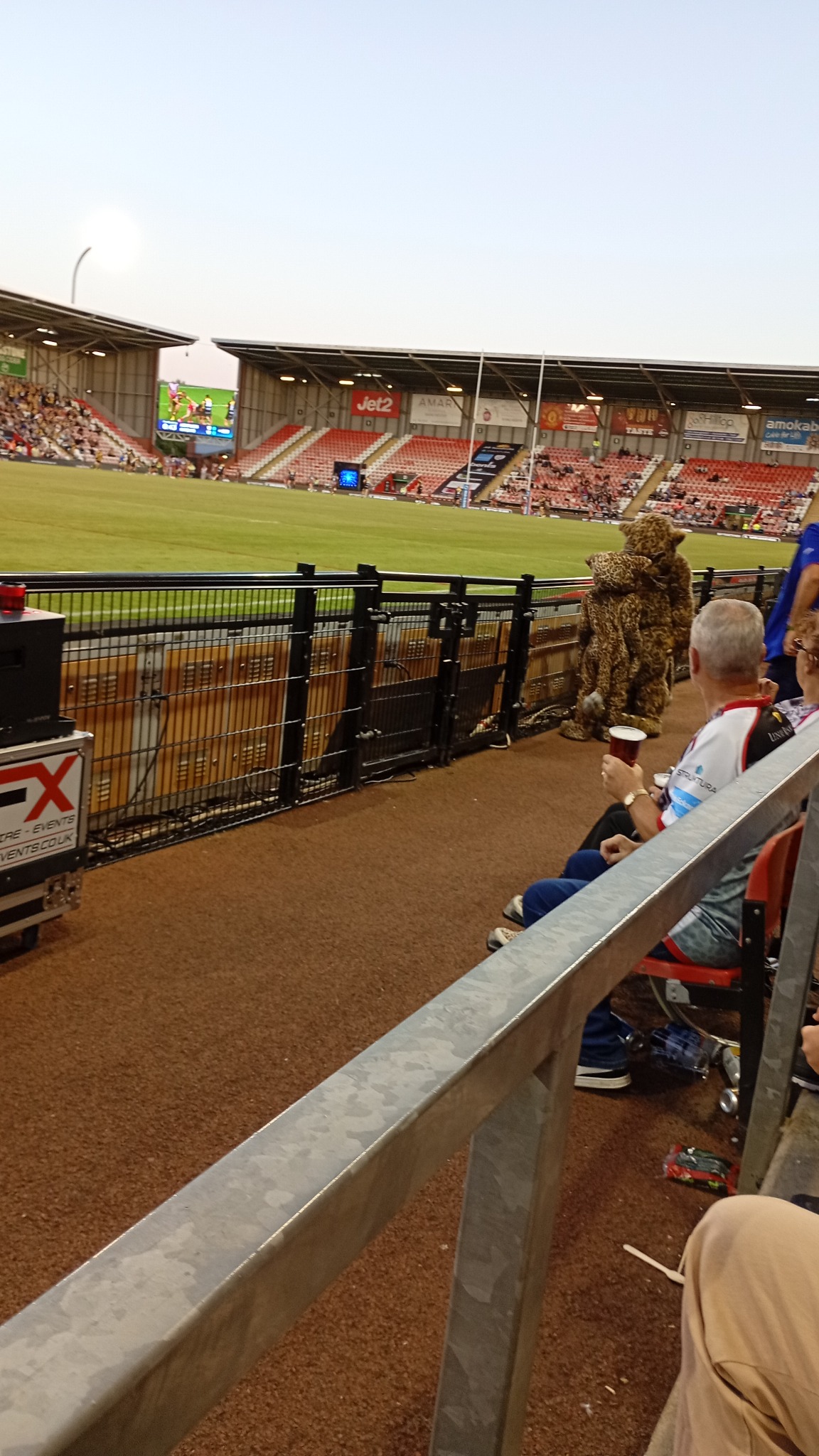 Leigh Leopards mascots greeting supporters beside the pitch