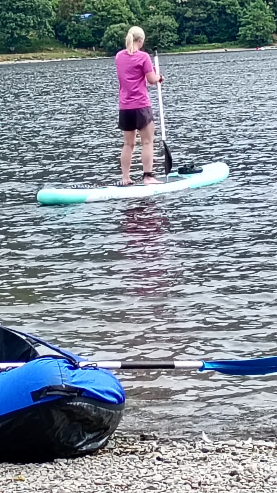 Dave's daughter standing on her paddleboard on Ullswater